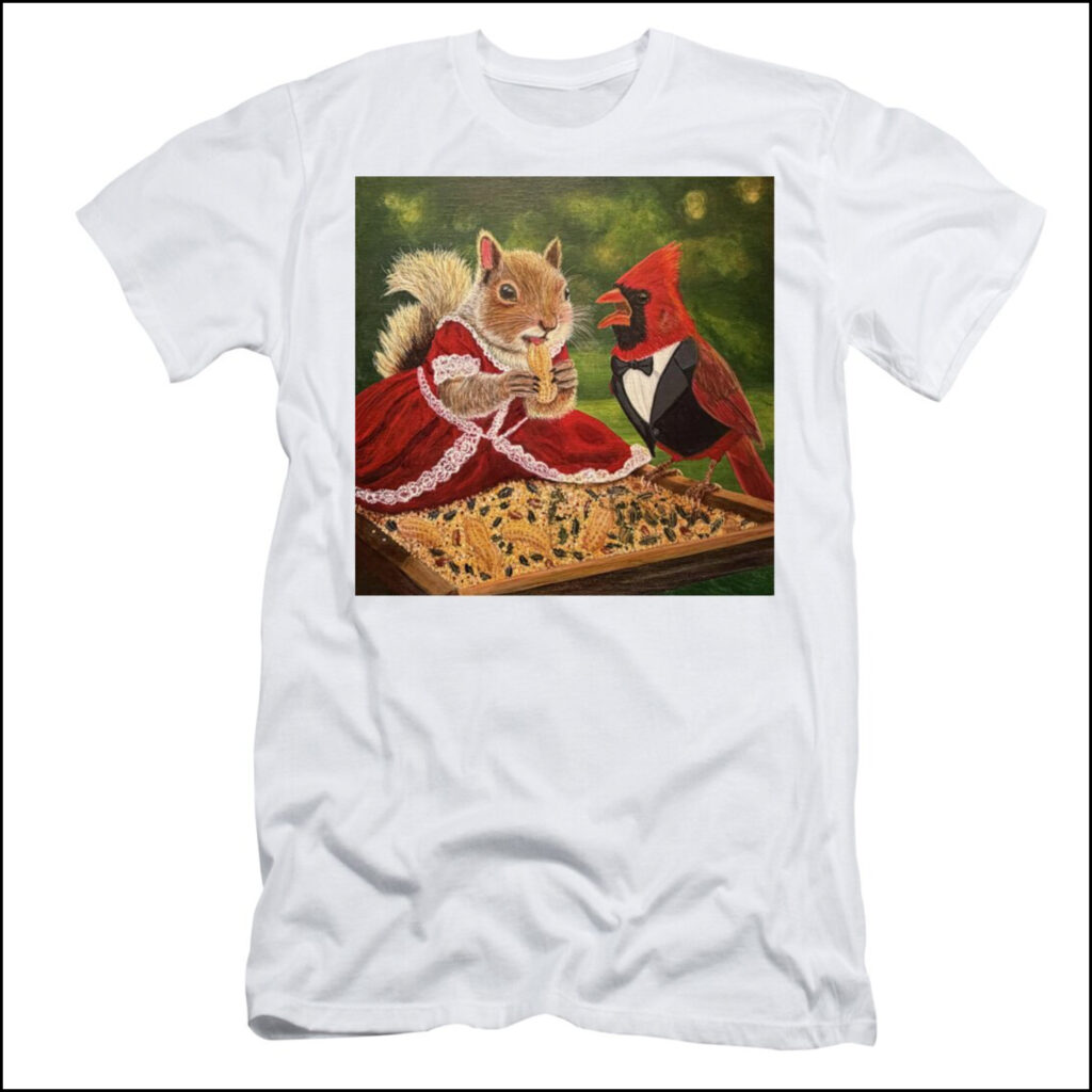 A white t-shirt featuring the painting Good Squirrel 1.0 by Pittsburgh artist The Bloomin Fool, depicting a squirrel in a lace-trimmed red dress eating a peanut while a male cardinal in a tuxedo protests.