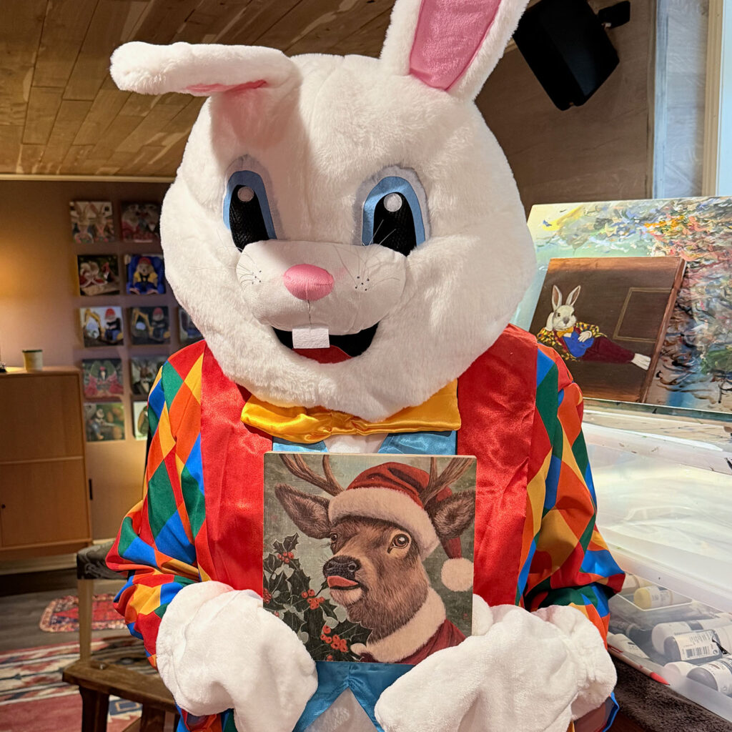 The Bloomin Fool holding the Rabbit Eating Tulips 1.0 coffee mug in the studio for a Fine Art America quality review.