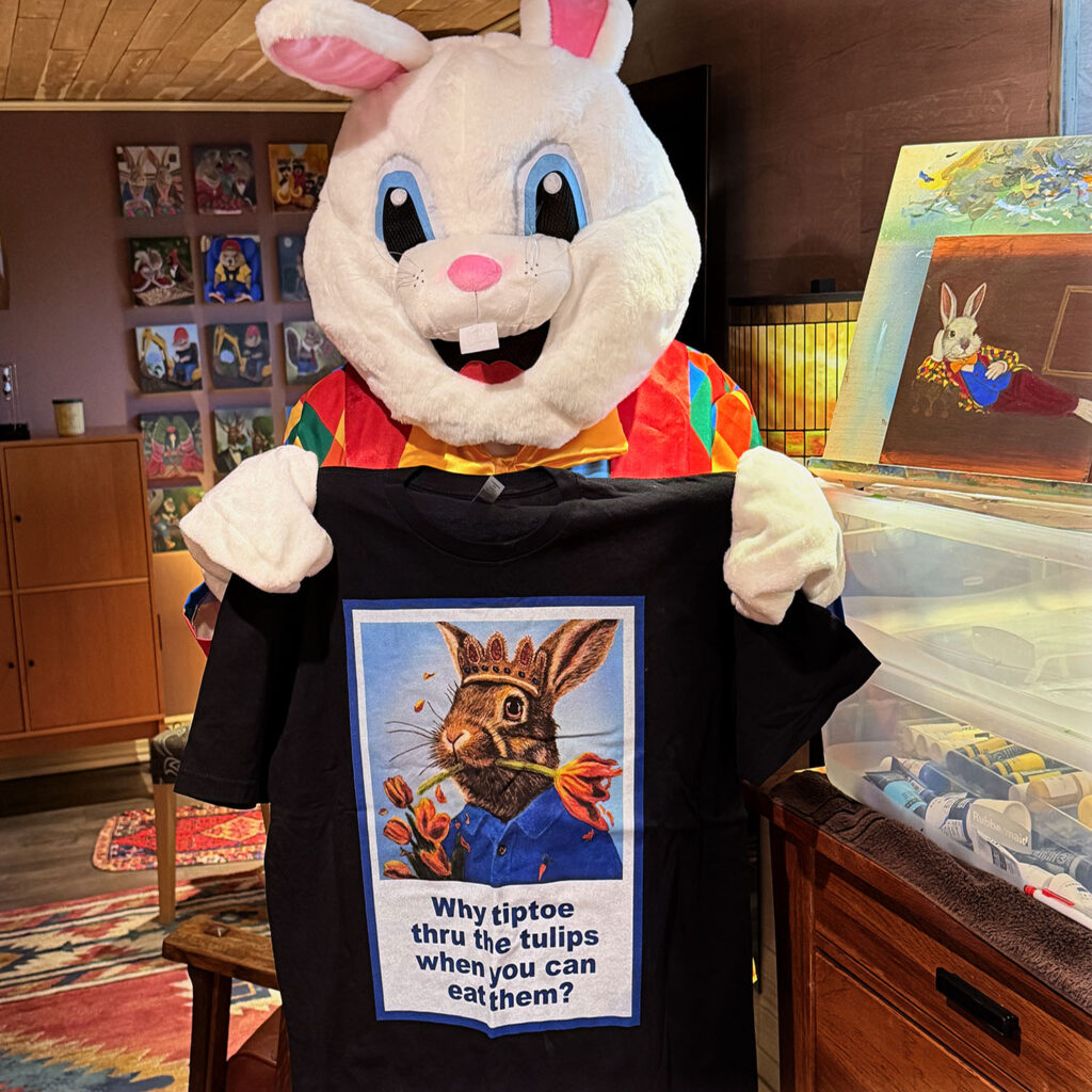 The Bloomin Fool holding the Rabbit Eating Tulips 1.0 t-shirt to review fabric print quality.