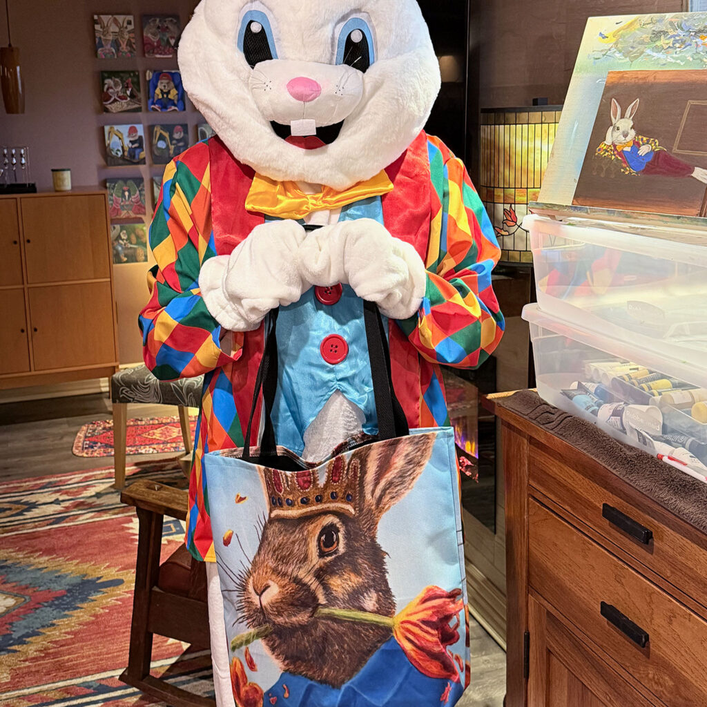The Bloomin Fool holding the Rabbit Eating Tulips 1.0 tote to evaluate material strength.
